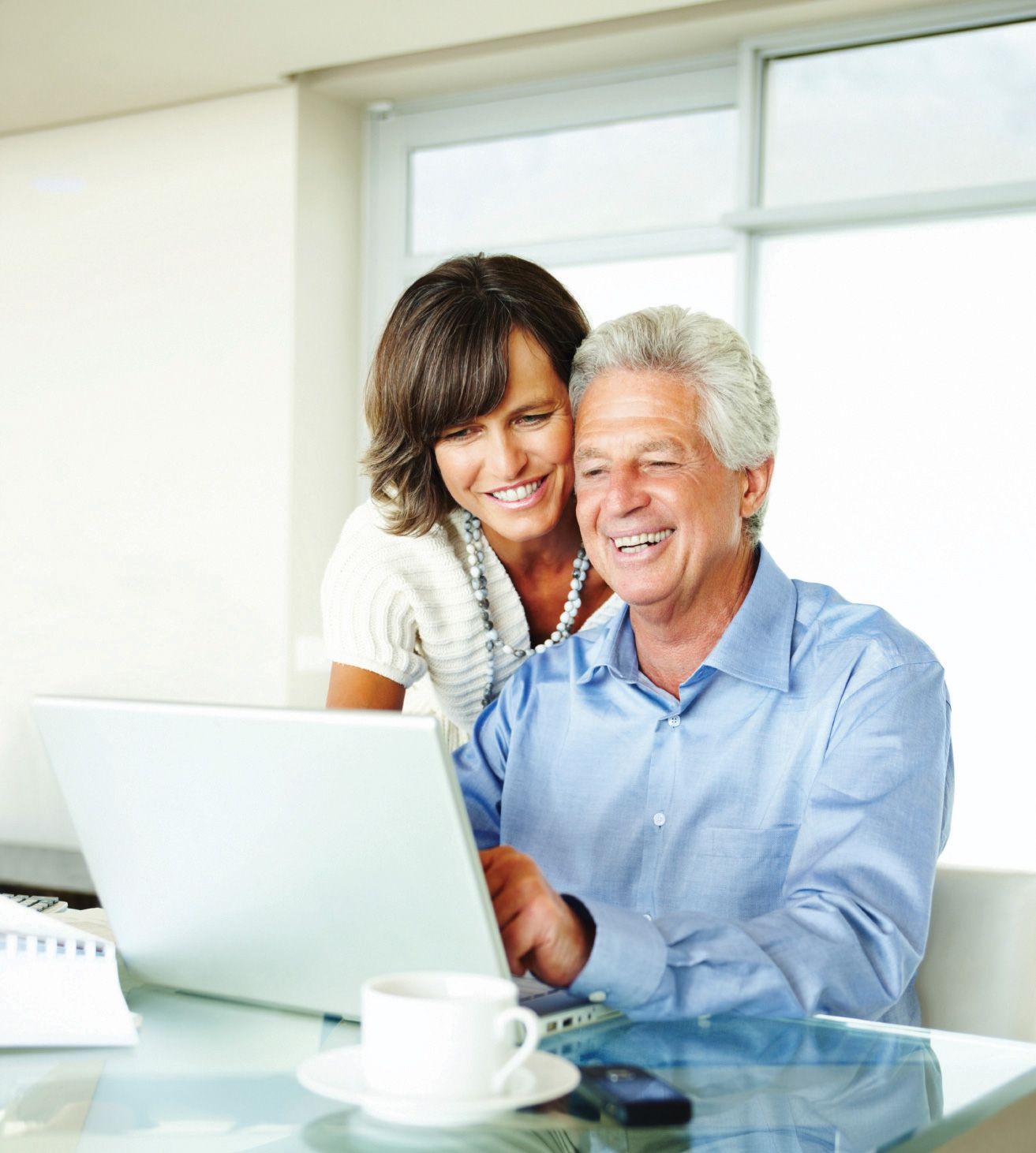 Picture of an older father and daughter looking at a desktop computer.